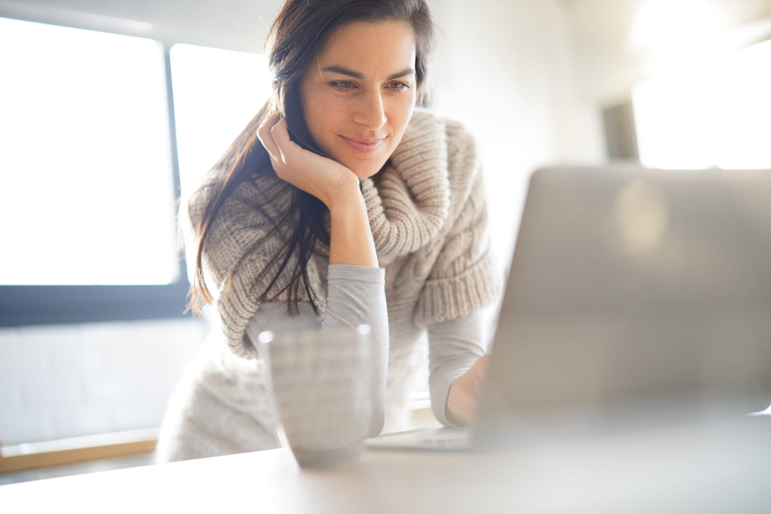 Middle-aged,Woman,Connected,On,Internet,With,Laptop,At,Home