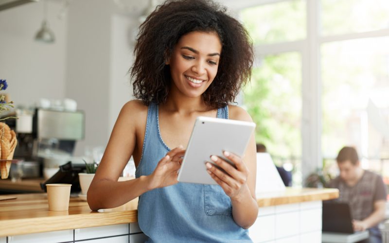 African female looking at results on her tablet
